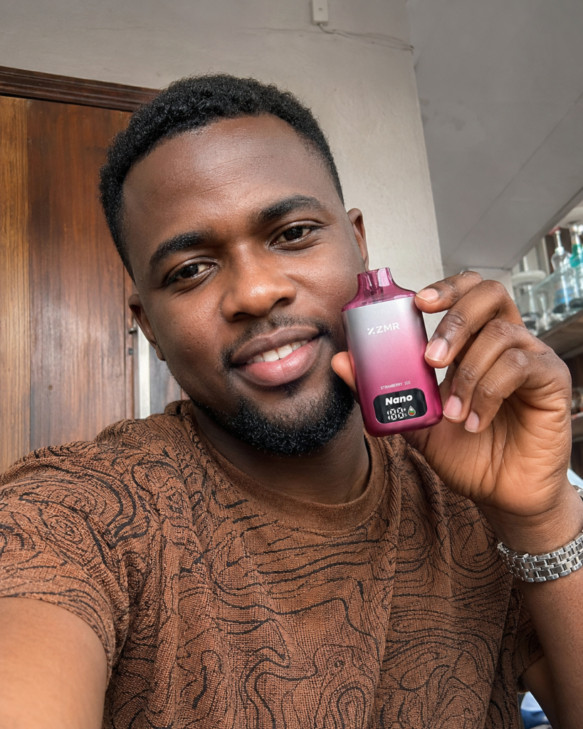 Man holding a pink ZMR Nano vape device