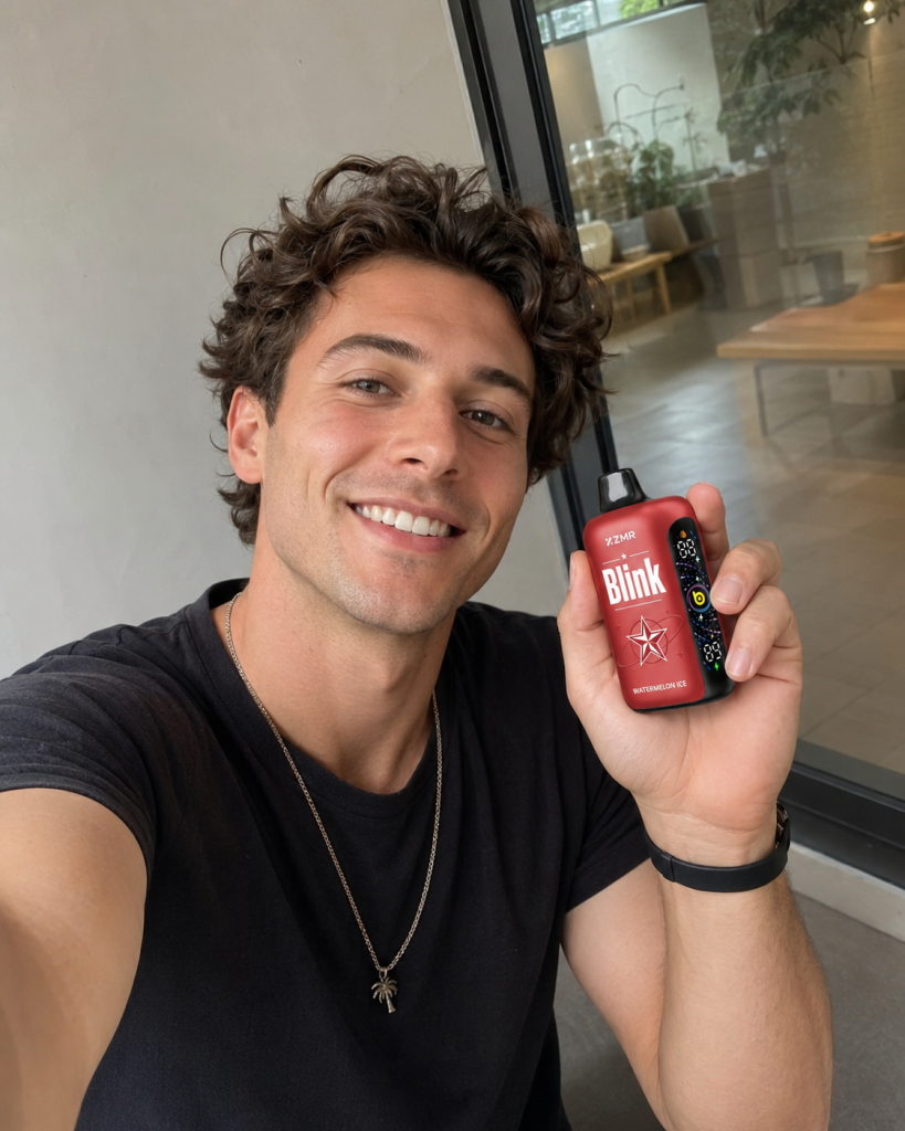 Man holding a red ZMR Blink vape device